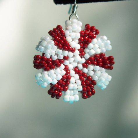 Embrace this holiday season with these adorable peppermint candy earrings! These double sided earrings feature the iconic peppermint swirl pattern and are about an inch in diameter and about a quarter of an inch thick. These are hand beaded with red and rainbow white seed beads. These earrings make the perfect gift! *They are available in clip on or hook earring. If you would like the clip on option, please leave me a note upon purchase and I will exchange it for no extra cost. *More colors comi Candy Cane Beaded Earrings, Christmas Brick Stitch Earrings, Holiday Earrings Diy, Christmas Beaded Earrings, Seed Bead Weaving, Seed Bead Tutorials, Candy Earrings, Double Sided Earrings, Holiday Beading