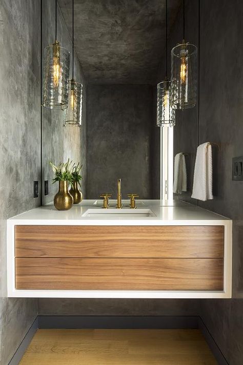 Chic modern powder room is lit by rippled glass light pendants hung in front of a frameless vanity mirror and over a tow tone mid-century modern floating washstand. Modern Bathroom Light Fixtures, Modern Powder Rooms, Modern Powder Room, Powder Room Mirror, Condo Bathroom, Modern Bathroom Lighting, Powder Room Design, Bathroom Pendant, Bathroom Pendant Lighting