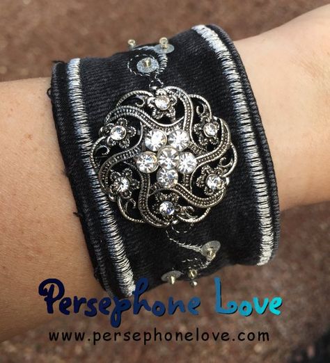 Black and silver #upcycled #recycled #denim cuff bracelet with rhinestone button, metallic embroidery, sequins and beads. One of my FAVORITE works! #PersephoneLove Denim Cuff Bracelet, Tea Towels Embroidery, Fairy Bracelets, Invisible Thread, Denim Bracelet, Boho Cuff Bracelet, Embroidery Denim, Boho Cuff, Embroidery Bracelets