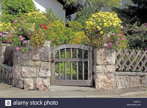 Download this stock image: Garden door, stone defensive wall, floral decoration, Germany, Bavaria, Upper Bavaria, door, little door, garden door, lowly, wooden, wooden, defensive wall,hunters fence Stone Garden Fence, Fence On Top Of Stone Wall, Diy Stone Fence, Stone Garden Wall, German Cottage, Masonry Design, House Planner, Cottage Woods, Stone Fence