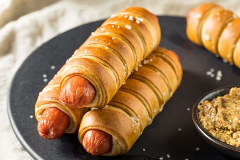 Pigs in a blanket are hot dogs filled with cheese and baked in a crescent roll wrap. Top them with an egg wash or poppy seeds for a twist. Crescent Wrapped Hot Dogs, Pigs In A Blanket Recipe Pillsbury, Hot Dog Crescent Rolls, Pigs In A Blanket Recipe, Easy Crescent Rolls, Wrapped Hot Dogs, Hot Dog Rolls, Gluten Free Pretzels, Homemade Pretzels