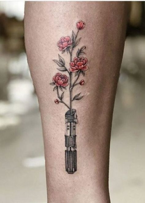 25 Star Wars Tattoo Ideas That You Will Absolutely Adore Starwars Tattoo Girly, Flower Lightsaber Tattoo, Star Wars Tattoo Flowers, Lightsaber With Flowers Tattoo, Starwars Flower Tattoo, Nerd Tattoos For Women, Lightsaber Flower Tattoo, Star Wars Tattoo Aesthetic, Star Wars Flower Tattoo