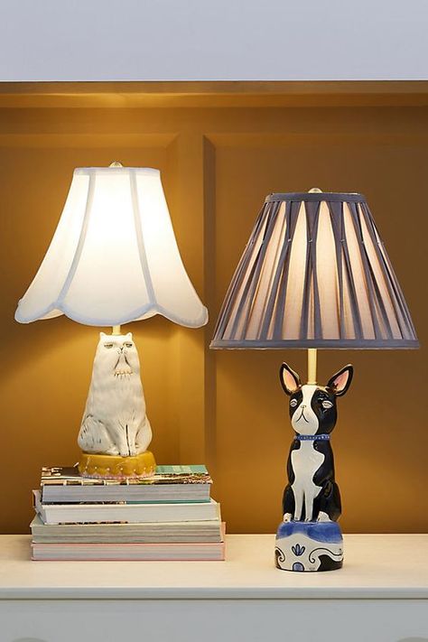 Infuse your space with charm through a whimsical, animal-shaped lamp. Featuring designs by Art Knacky in collaboration with Anthropologie of a grouchy cat or a nonchalant Boston Terrier, these table lamps are sure to incite excitement among pet lovers and kitsch collectors alike. About Art Knacky With a passion for collecting small things from tiny toys to dollhouse miniatures Andrea Shemilt Kashanipour launched Art Knacky, a miniature empire for those who seek artistic frivolities..... Table Lamps Design, Estilo Kitsch, Lamps Design, Cat Lamp, Luxury Table Lamps, Pile Of Books, Luxury Table, Modern Lamp, Garden Lamps