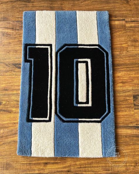 Introducing the Messi’s Jersey Rug, the ultimate tribute to the football legend Lionel Messi. Crafted with precision and passion, this rug features the iconic number 10 jersey design worn by Messi throughout his illustrious career. Made from high-quality materials, it adds a touch of sporting elegance to any room. Whether you’re a die-hard football fan or simply appreciate great design, the Messi 10 No. Jersey Rug is a must-have for your collection. Bring the spirit of the beautiful game into... Tufting Ideas, Messi Fans, Statement Rug, The Beautiful Game, Rug Ideas, Messi 10, Number 10, Mommy Life, Great Design