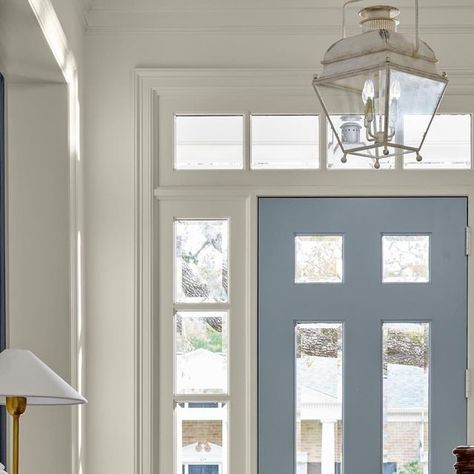 Kathy Kuo Home on Instagram: "The entrance to your home is like the start of a good book: There is so much wonder and possibility in the story that is about to unfold. The first few pages—aka your foyer—is just the beginning! 

📷 @nathanschroderphoto @jbheditorial

Built by @renaudinbuilders" Blue Interior Front Door, Houston Design, Beautiful Entryways, Southern Design, Entry Design, Light Layers, Small Lanterns, Timeless Interiors, Foyer Design