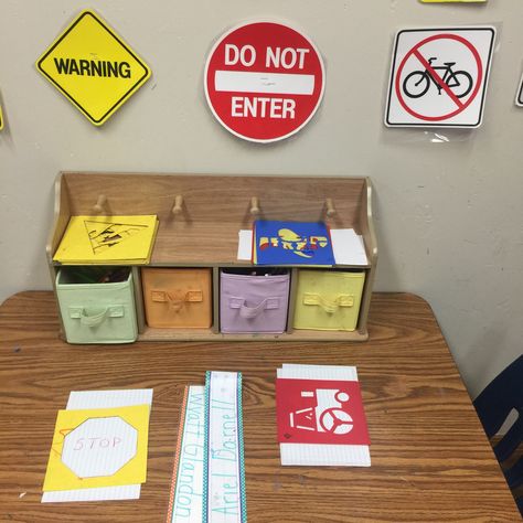 Sign making in preschool writing center for transportation unit. Colored pencils, shape stencil, transportation stencils, and sign decor on wall Signs Unit Preschool, Preschool Writing Center, Environmental Print Activities, Prek Transportation, Writing Center Preschool, Pre K Lesson Plans, Creative Curriculum Preschool, Land Transport, Transportation Unit