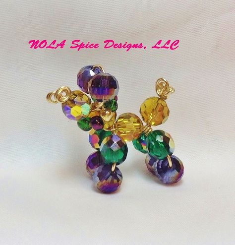 As children growing up in New Orleans, we made tiny bead dogs from the broken strands of plastic beads that we were so dilingent about catching, at the Mardi Gras parades.These memories are the inspiration for our Bead Dog creations. I have taken those childhood charms and made them grown up by creating jewelry and decorative pieces from glass, pearls and crystals. https://www.facebook.com/?ref=logo#!/NOLASpiceDesigns https://twitter.com/NOLASpiceDesign Green Gold Necklace, Wig Jig, Mardi Gras Crafts, Mardi Gra, Carnival Decorations, Irish Decor, Mardi Gras Parade, New Orleans Mardi Gras, Mardi Gras Decorations