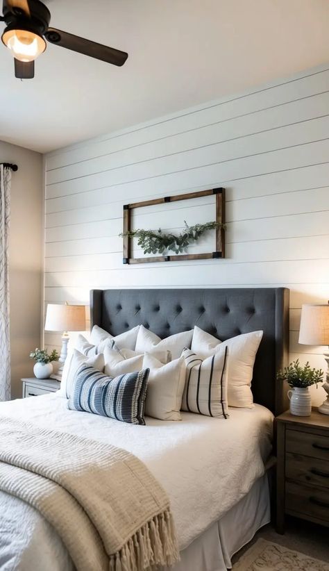 Sophisticated farmhouse-inspired master bedroom with a tufted grey headboard, chunky knit blanket, and wooden beams. Master Bedrooms Farmhouse, Neutral Farmhouse Bedroom, Modern Farmhouse Bedrooms, Shiplap Bedroom, Modern Farmhouse Bedroom Ideas, Farmhouse Bedroom Ideas, Gorgeous Farmhouse, Lake Ideas, Modern Farmhouse Bedroom