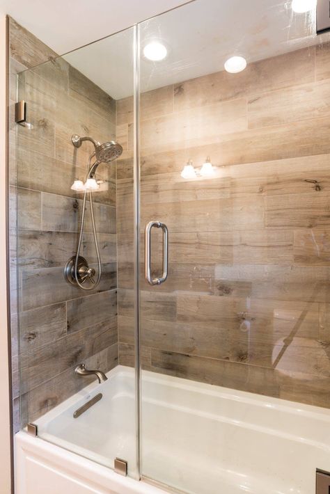 Wood Tile Shower Ideas With Tub, Wood Tile Tub Shower Combo, Wood Look Tile In Shower Walk In, Wood Tile Tub Surround, Wood Accents In Bathroom, Wood Tile Bathroom Ideas, Wood Tile Bathtub, Wood Grain Tile Bathroom, Wood Tile In Shower