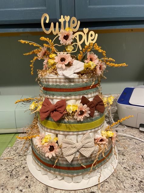 Fall theme “Cutie Pie” Baby Shower Diaper Cake Little Cutie Pie Baby Shower Theme, Diaper Cake Fall Theme, Cutie Pie Baby Shower Theme Fall, Pie Themed Baby Shower Ideas, Cutie Pie Baby Shower Theme, Fall Diaper Cake, November Baby Shower, Baby Shower Diaper Cake, Cake Inspo