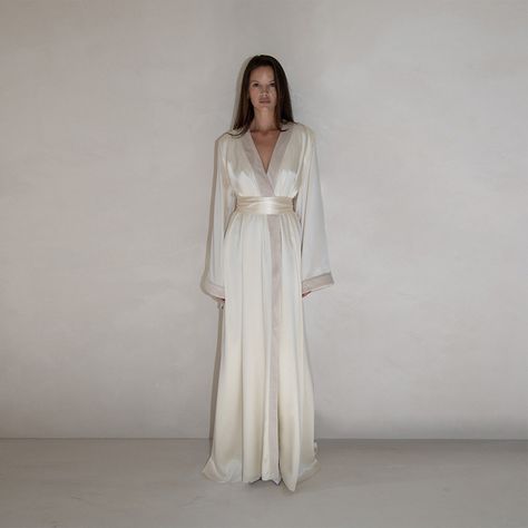 Robe Gown crafted in ivory silk , featuring a floor length silhouette , wrap design , tied waist , kimono inspired sleeves , velvet trim detailing , and train . This is the perfect evening gown. 100 % Silk Silky Robe Aesthetic, Light Blue Silk Robe, Silk Dress Sleepwear, Luxury Silk Robe, Wrap Kimono Dress, Bath Robe White, White Satin Pajama Dress, White Silk Dress With Sleeves, 100% Silk Dress