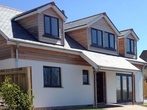 This development was of a 4 Bed-roomed dormer bungalow located in the centre of Helston. It was designed to provide a more contemporary look to make it stand out from the neighbouring properties. We used Western red cedar cladding and natural slate to enhance the quality look of the property. Cedar Dormers, Dormer Extension, Exterior Wood Cladding, Western Red Cedar Cladding, Bungalow Conversion, Contemporary Bungalow, Dormer Bungalow, Bungalow Extensions, Modern Bungalow Exterior