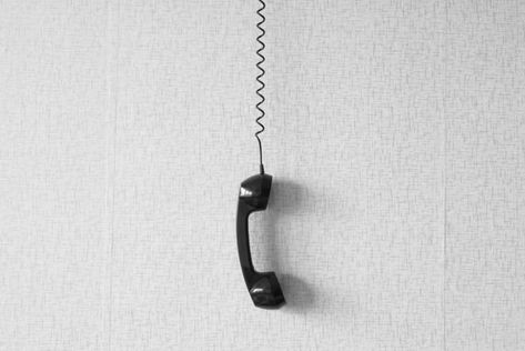 black old handset with a wire hang against wallpaper texture. black plastic telephone hanging by the cord.Retro Phone Cord - Vintage Telephone Handset Receiver hanging by the Cord down Numbers To Call, Wallpaper Texture, Phone Cords, Wall Phone, Vintage Phone, Doodle Icon, Retro Phone, Vintage Phones, Cell Phone Number