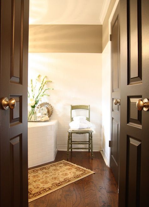 Our powder bath door  I'm loving my new dark doors. I've talked about this subject here before. It is something that I frequently tell my c... Dark Interior Doors, Brown Interior Doors, Grey Wall Color, Painted Interior Doors, Black Interior Doors, Brown Doors, Brown Paint, Retro Interior, Live Beautifully