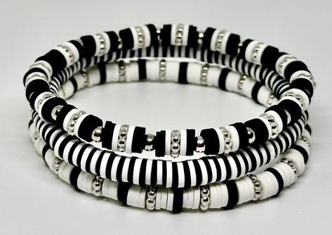 Set of 3 Black and White, hand beaded, stretch bracelets. Each strand is made with 6mm Heishi beads with silver accents. Can be customized with wording of your choice. Bracelet Perle Heishi Homme, Black And White Clay Bracelet, Heishi Bracelet Patterns, Black And White Clay Bead Bracelet, Flat Beads, Western Clay Bead Bracelet Ideas, Black Beads Bracelet, Black And White Bracelets, Bracelet Heishi