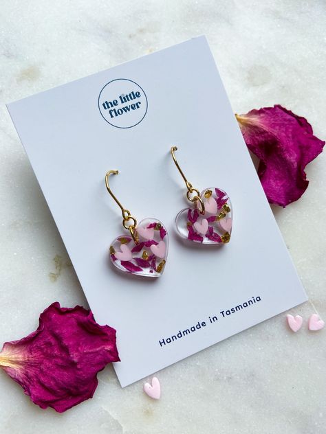 "Valentines Day Flower Heart Earrings, Real flower jewellery, resin earrings, heart shaped earrings, pink heart jewellery, gold and silver   14K Gold-Plated Flower Huggies from our Valentines Day Collection. Handcrafted with Tasmanian grown Rose petals.   Give the gift of love this Valentines Day with our Flower Huggie Valentines edition! * Made with Tasmanian grown Roses * Available in Gold and Silver * Handcrafted in Tasmania * Hypoallergenic  * Made to order Use Code \"VALENTINESDAY\" for 10% off! The Little Flower Handmade is a small female owned business located in Hobart Tasmania, which used locally grown flowers to craft timeless pieces of jewellery.  Follow us on Instagram @littleflowerearrings  Thanks for your support! Agnes  The Little Flower Handmade." Resin Heart Earrings, Resin Flower Earrings, Resin Jewellery Ideas, Real Flower Jewellery, Jewellery Resin, Diy Resin Earrings, Pink Heart Jewelry, Dried Flower Jewelry, Schmuck Gold