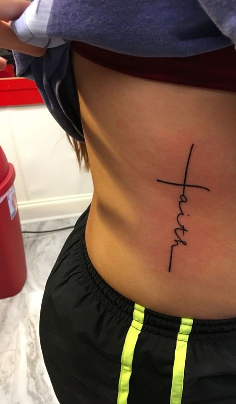 54 Beautiful Faith Tattoo Designs For You In 2021 – Artistic Haven Faith Tattoo Side Rib, Faith Tattoo On Ribs, Faith Tattoo Ribs, Cross On Side Ribs, Cross On Spine Tattoo, Faith Rib Tattoo, Blessed Rib Tattoo, Small Side Stomach Tattoos, Cross Stomach Tattoo