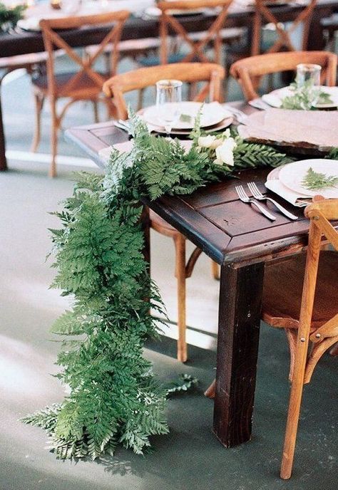 Runners of green leather leaf cascading off the sides of the tables to the ground with scattered tall copper LED votives Wedding Fern Centerpiece, Fern Table Runner, Fern Garland, Fern Centerpiece, 12 Tables, Wedding Table Garland, Blue Wedding Centerpieces, Fern Wedding, Table Garland