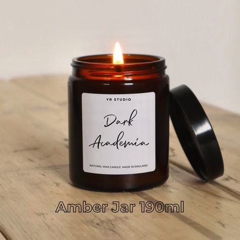 Dark Academia Literary Candle | Mystery & Fantasy Book Lover Gift Discover the allure of mystery and imagination with our Dark Academia Literary Candle, a handcrafted gem for book lovers and mystery enthusiasts. Immerse yourself in the essence of your favorite mystery, fantasy, and fiction with every light. Perfect for gifting or personal indulgence, it's an invitation to literary adventures and the academic aesthetic. Ideal for fans of unique, book-inspired treasures. ScentDark, rich pomegranat Literary Candles, Academic Aesthetic, Product Packing, Candle Safety, Clear Jars, Wood Candle, Amber Jars, Clear Glass Jars, Fantasy Book