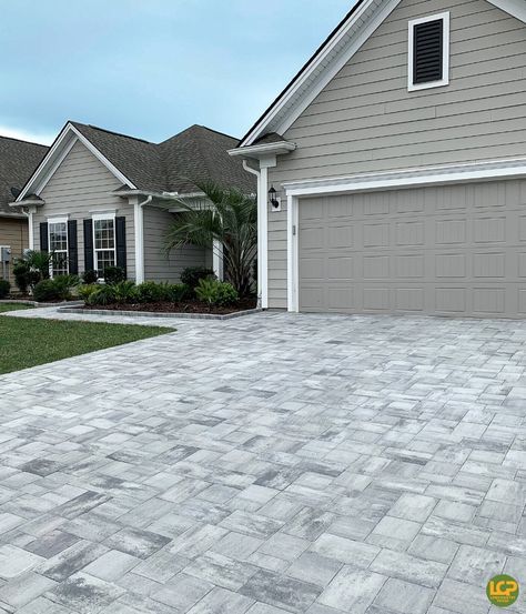 Gorgeous driveway remodel featuring our newest paver color, Charleston Pearl. 😍 Not only do pavers look better than the old concrete, they also increased this homes value!  #lowcountrypaver #drivewaygoals #exteriorinspo #paverdriveway #homesweethome #lowcountryliving #homeimprovements #homeimprovementprojects Paver Driveway Extension, Driveway Remodel, Paver Colors, Driveway Pavers Design, Driveway Pavers, Tan House, Old Concrete, Paver Designs, Pathway Landscaping