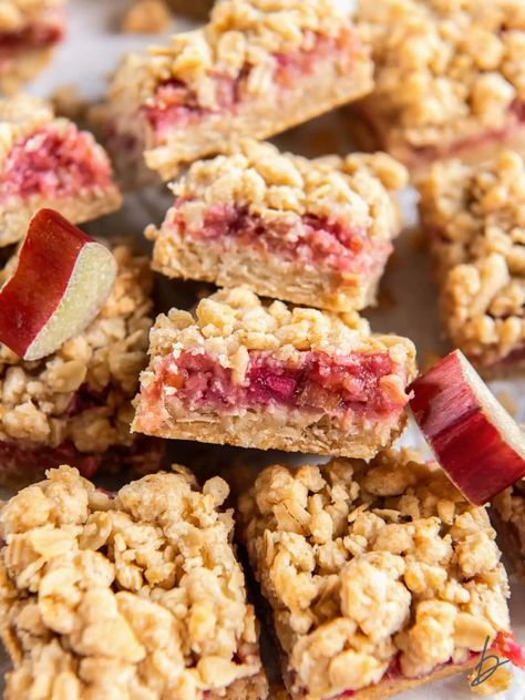 rhubarb crumble bar showing layers of crumb and filling leaning on another bar. Rhubarb Crumble Bars, Rhubarb Bars Recipes, Rhubarb Squares, Strawberry Rhubarb Bars, Almond Paste Recipes, Oat Crust, Rhubarb Bars, Blueberry Crumble Bars, Crumb Bars