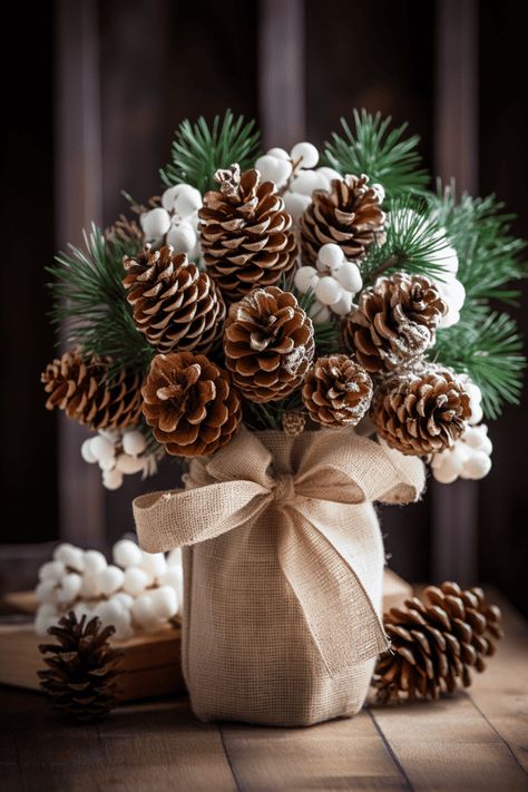 These rustic bunches look stellar with simple ceramic dishes; imagine a canvas of white, where your centerpiece paints the color. #Christmas #Holidays #HomeDecor Christmas Pine Cone Decorations, Simple Rustic Christmas Decor, Diy Magnolia Wreath, Pine Cone Christmas Decorations, Burlap Ornaments, Diy Natal, Christmas Decorations Centerpiece, Elf Decorations, Christmas Pine Cones