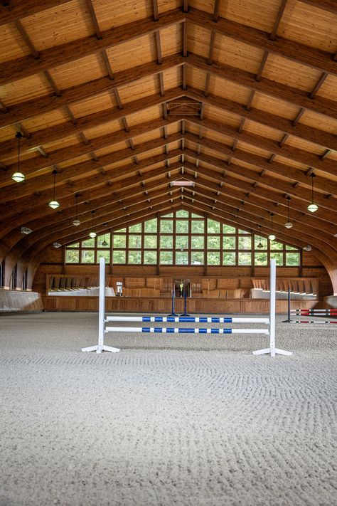 This beautiful 30,000-square-foot equestrian facility includes an octagonal timber frame barn and an arched riding arena nestled into a hillside. Fine custom details can be found throughout, but the most unique feature may be the arena windows that open fully like garage doors. Equine Facility, Horse Riding Arena, Riding Arena, Timber Frame Barn, Riding Arenas, Equestrian Facilities, Cedar Siding, Barn Design, Building Permits