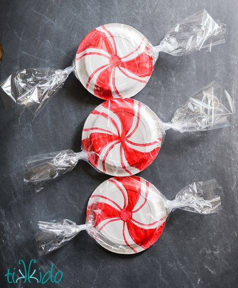 Paper plates decorated to look like giant peppermint candies. Giant Peppermint Candy, Peppermint Candy Decorations, Candy Christmas Garland, Peppermint Christmas Decor, Christmas In July Decorations, Candy Decorations Diy, Diy Christmas Candy, Candy Cane Decorations, Peppermint Christmas