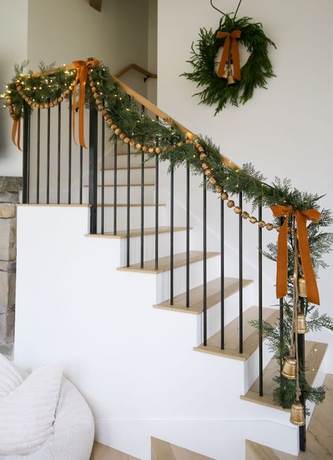 HOLIDAY / I'm sharing this country farmhouse holiday Christmas decor with layered garland staircase. Green garland paired with a velvet ribbon and hanging cow bells and gold beads. Shop my favorites! | SBK Living Staircase Styling, Layered Garland, Holiday Staircase, Garland Staircase, Christmas Garland Staircase, Thanksgiving Table Setup, The Mcgee Home, Christmas Staircase, Staircase Decor