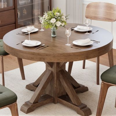 A timeless blend of classic countryside style and modern appeal. With its rock-solid cross-base design and top-notch quality materials, this dining table guarantees long-lasting reliability. Measuring at 47.25 inches in diameter, it comfortably seats four people, making it perfect for both dining rooms and kitchens. Effortless assembly and an elegant presence complete the package. Elevate your dining experience with our Solid Wood Pedestal Dining Table. | August Grove® Bortman 47.2 L x 47.2 W Di Round Kitchen Table Ideas, Wayfair Finds, Wooden Extendable Dining Table, Wood Pedestal Dining Table, Wood Base Dining Table, Round Pedestal Dining Table, Round Dining Table Modern, Dining Table Wood, Round Kitchen Table