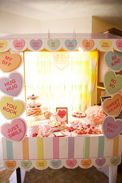 Food table setup at valentines party with heart backdrop and food on the table Valentines Conversation Hearts Decor, Conversation Heart Decor, Candy Heart Decor, Conversation Hearts Decor, Valentines Display, Diy Craft Party, Sweetheart Dance, Hearts Decor, Valentine Bulletin Boards