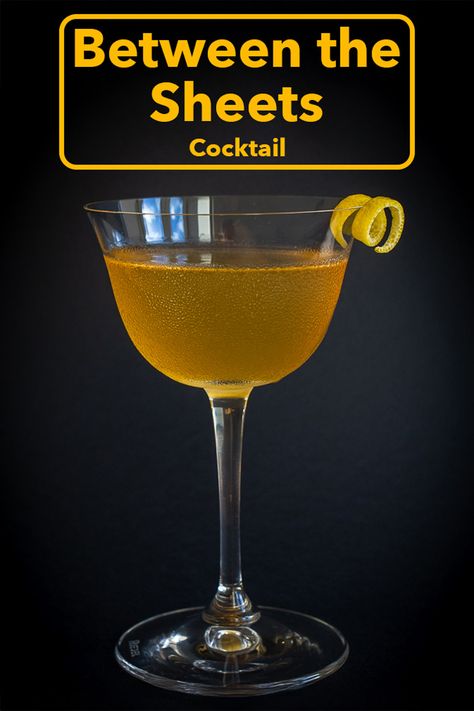 Pinterest image: photo of a Between the Sheets cocktail with caption reading "Between the Sheets Cocktail" Orange Rum Cocktail, Savory Rum Cocktails, Manhattan Cocktail Variations, Between The Sheets Cocktail, White Lady Cocktail, Cognac Cocktails, Lemon Peel Garnish, Spiced Rum Cocktails Captain Morgan, Cognac Cocktail