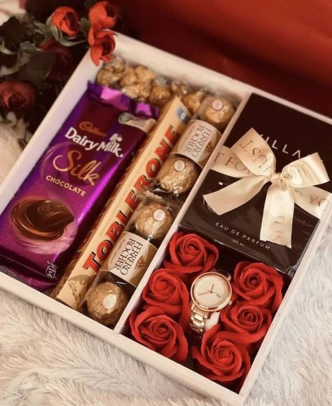 ORDER NOW✨ Show elegance with our premium gift box – the perfect blend of luxury and thoughtfulness. This box features a selection of irresistible chocolates like Cadbury Dairy Milk Silk, Toblerone, and Ferrero Rocher, alongside a sophisticated perfume and a timeless wristwatch, all nestled among beautiful red roses. Perfect for making special moments unforgettable! 🎁💫 #GestureveGifting #LuxuryGiftBox #SpecialMoments #GiftOfElegance #GestureveMoments #ChocolateLovers #PerfectGift #GiftBoxIde... Dairy Milk Silk, Silk Chocolate, Red Chocolate, Gifts Wrapping, Cadbury Dairy Milk, Beautiful Red Roses, Chocolate Gift Boxes, Rose Gift, Ferrero Rocher