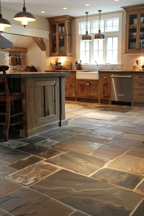 Add a unique twist to your kitchen with farmhouse kitchen flooring options that combine rustic and modern elements. 🏡🍴 Rustic Flooring Tile, Kitchen Floor Next To Hardwood, Wood Cabinets With Tile Floor, Rustic Floor Tiles Living Room, Log Cabin Concrete Floors, Dark Stone Kitchen Floor, Farmhouse Kitchen With Tile Floor, Home Flooring Ideas Tile, Rustic Kitchen Flooring Ideas