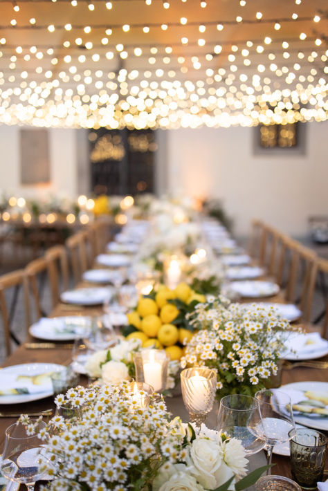 The floral arrangements by Deep Flowers were a combination of daisies and lemon-colored accents, representing simplicity and brightness. The white and green daisies were the epitome of purity, while the lemony hues added a sense of freshness and enthusiasm to the entire event. Wedding Yellow And Green, Chamomile Table Decoration, Daisy Wedding Theme Decor, Daisy Table Decorations, Chamomile Wedding Decor, Daisy Centerpiece Ideas, White Daisy Wedding Decorations, Yellow Daisies Wedding, Lemon Wedding Decor