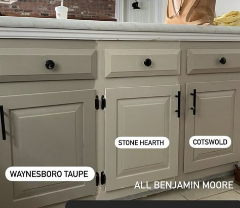 Tan Cabinets With Black Hardware, Pebble Cabinet Color, How To Take Down Cabinets, Kitch Cabinet Colors, Pretty Cabinet Colors, Best Greige For Kitchen Cabinets, Taupe Grey Kitchen Cabinets, Beige Colour Kitchen Cabinets, Taupe Cabinets Black Hardware