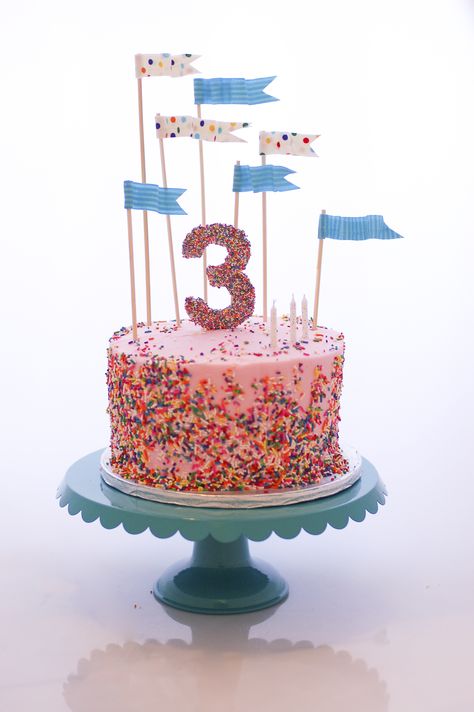 Sprinkle Cake - My now-three-year-old daughter requested a sprinkles themed… Flag Cake Topper, Sprinkles Birthday Party, Flag Cake, Number Cake Toppers, Sprinkle Party, Cake Topper Tutorial, Pink Frosting, Sprinkle Cake, Number Cakes