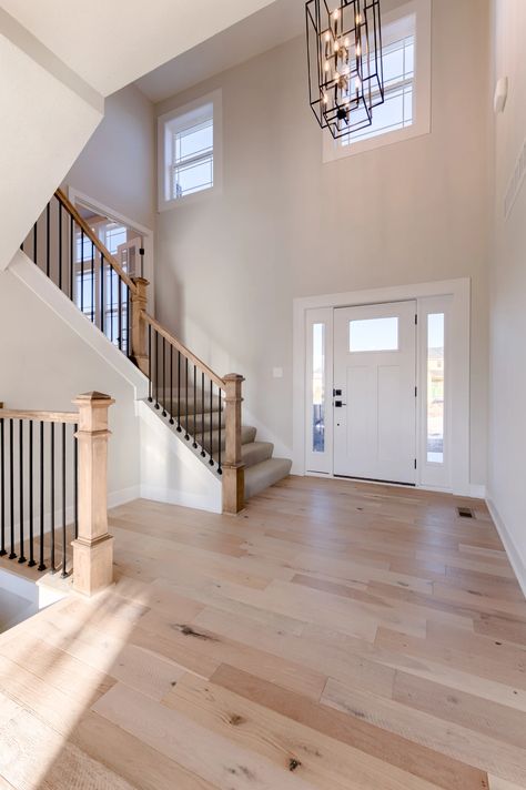 Staircase With Stone Wall, Stairs Right Inside Front Door, Closing Off Two Story Foyer, Drywall Staircase Makeover, Knee Wall Stairs, Painting Staircase Ideas, Farmhouse Entryway With Stairs, Stairs At Entryway, Staircase Spindle Ideas