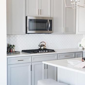 White Glass Arabesque Tiles with Gray Shaker Cabinets Slate Appliances Kitchen, Slate Appliances, Appliance Storage, Kitchen Decor Styles, Kitchen Aid Appliances, Black Appliances, New House Kitchen, Ge Appliances, Appliances Kitchen