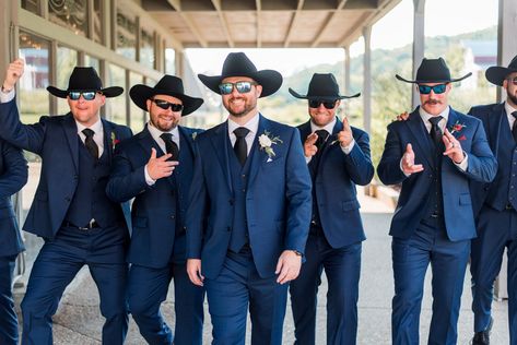 No Nashville wedding is complete without cowboy hats—here's your proof. This groom and groomsmen group had to take some personality pictures in their hats and glasses, these make for fun photos! | John Myers Photography & Videography Navy Blue Suit With Cowboy Boots, Farm Wedding Groomsmen, Suits And Cowboy Hats Wedding, Groomsmen With Cowboy Hats, Navy Blue Groomsmen Suits Cowboy Boots, Groom With Cowboy Hat, Groomsmen Cowboy Hats, Cowboy Hat Wedding Grooms, Rustic Groomsmen Attire Jeans