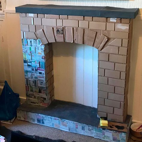 This DIY cardboard fireplace idea is really thinking outside the box! How To Make A Fireplace Out Of Boxes, Box Fireplace Cardboard, Diy Fake Fireplace Cardboard, Cardboard Fireplace Diy, Diy Cardboard Fireplace, Faux Fireplace Diy Cardboard, Fireplace Craft, Real Fireplace, Diy Christmas Fireplace