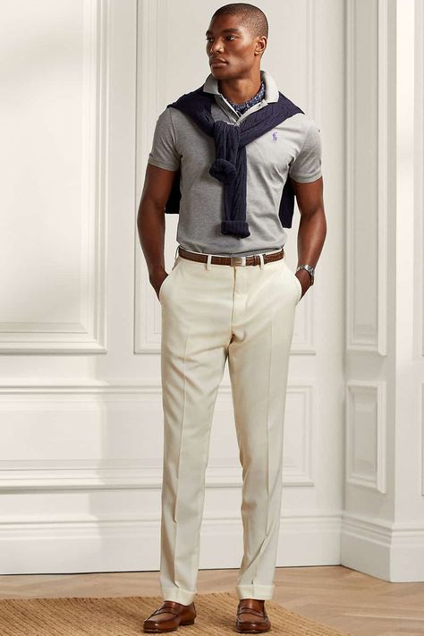 Men's beige pants, grey polo shirt navy sweater and brown leather loafers outfit. This outfit first appeared in the article: 20 Modern Preppy Outfits For Men: How To Get The Ivy League Look In 2022, on MensFlair.com Polo Tucked In Men, Gray Polo Outfit Men, Preppy Outfit Men, Preppy Outfits For Men, Grey Polo Outfit Men, Leather Loafers Outfit, Preppy Work Outfit, Preppy Outfits Men, Ivy League Look