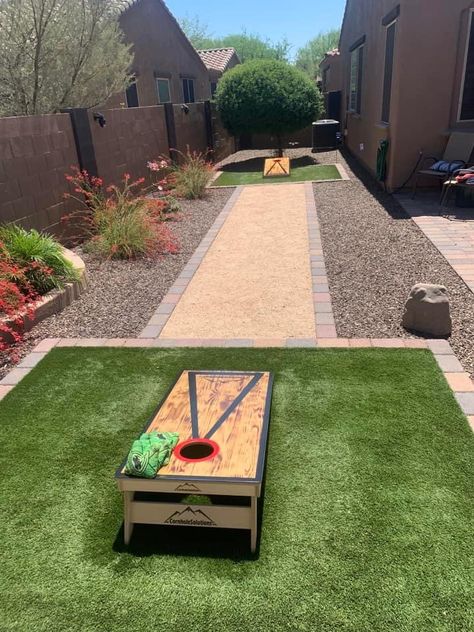 Backyard Rock Landscaping Ideas, Backyard Corn Hole Court, Cornhole Yard Ideas, Corn Hole Pit Ideas, Corn Hole Court Backyard Ideas, Cornhole Playing Area, Backyard Cornhole Court, Corn Hole Area In Backyard, Corn Hole Backyard Area