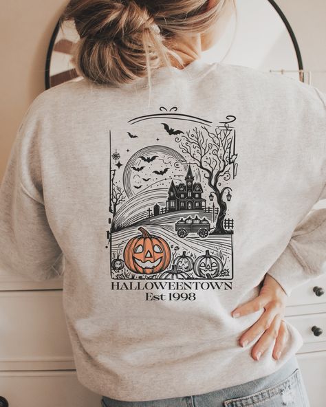 🎃👻 Step into Spooky Season with our Halloween Town University Crewneck! 👻🎃 Are you ready to embrace the spirit of Halloween? Our exclusive Halloween Town University sweatshirt is here to make your spooky season stylish and cozy! With a striking front and back design, this ash gray Gildan 18000 crewneck is perfect for those who know that “being normal is vastly overrated.” ✨ Features: • Front: Halloween Town University logo with a fierce jack-o’-lantern 🎃 • Back: Intricate haunted scene w... Being Normal Is Vastly Overrated, Halloween Town University, University Crewneck, University Logo, University Sweatshirts, Ash Gray, Halloween Town, Jack O, Back Design