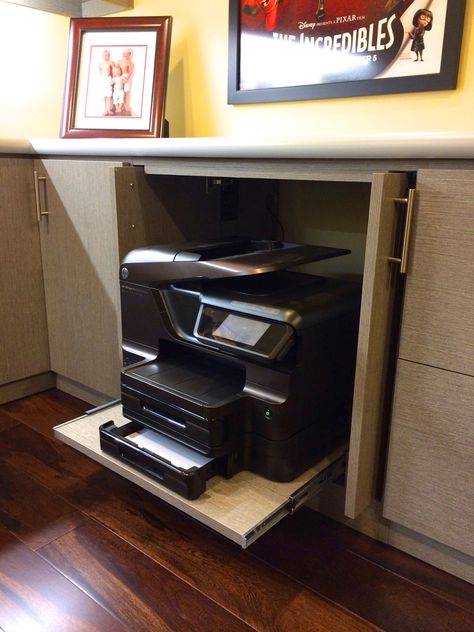 Printer hide - away!   Many of us are using our printers less these days and in a cozy home we generally do not want to see this large machinery out to clutter a fine designed home office. Pocket doors and sliding shelf makes for a neat hide-away for any printer or machine.  Created #HomeOffice by #Malka and #RCCabinetsandClosets of #Sonoma  #OfficePrinter #HomeOffice #InteriorDesign #ProfessionalOrganizer #ProfessionCabinetDesign #PrinterShelf #PrinterCabinet Hiding Printer In Home Office, Hide Printer In Office, Home Office With Printer, Large Printer Storage Ideas, Office Pocket Doors, Printer Storage Ideas, Office Decor Professional Work, Printer Drawer, Sliding Shelf