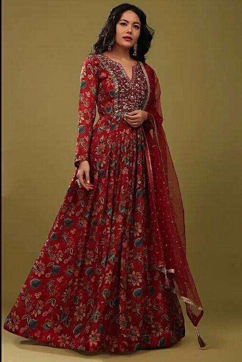 Diwali is around the corner, this tomato red anarkali suit in floral jaal print and embroidery which comes in a slash neckline with full sleeves will be perfect for Diwali party. The bodice and yoke are embroidered in random work, zardosi and a touch of stonework and outlining in mirror work. #Diwali #2022 #festival # Anarkali Red Anarkali Suits, Red Anarkali, Full Sleeves Dress, Indian Kurti Designs, Print And Embroidery, Long Gown Design, Resham Work, Designer Kurti Patterns, Kurti Patterns