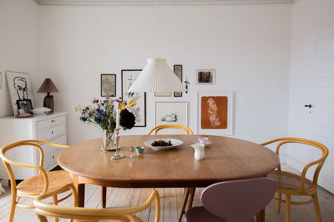 This Danish Apartment, Filled With Books and Rugs, Is an Empty Nester's Oasis | Cup of Jo Danish Apartment, Home Bookshelves, Yellow Lamp, Le Klint, Cup Of Jo, Small Apartment Living Room, Ikea Cabinets, Small Apartment Living, Nordic Home