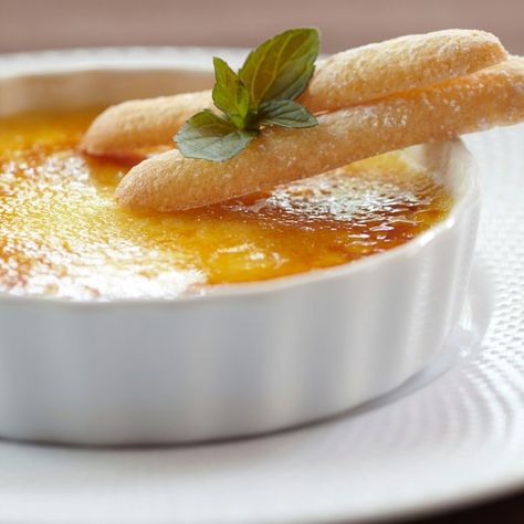 The simple addition of orange zest adds a delightful dimension to this French classic, with tangy citrus notes enhancing the creamy-sweet custard. Home cooks who don't have a chef's blowtorch can easily use their broiler/grill to caramelize the sugar topping. But remember to leave the oven door slightly open and keep watch. A golden sugar crust can quickly turn black if left too long under the flame.                  This dessert was born of a collaboration between the cellar and... Door Slightly Open, Crème Brûlée Recipe, Creme Brulee Recipe, Brulee Recipe, French Classic, Bitter Orange, Signature Dishes, Orange Zest, Roasting Pan