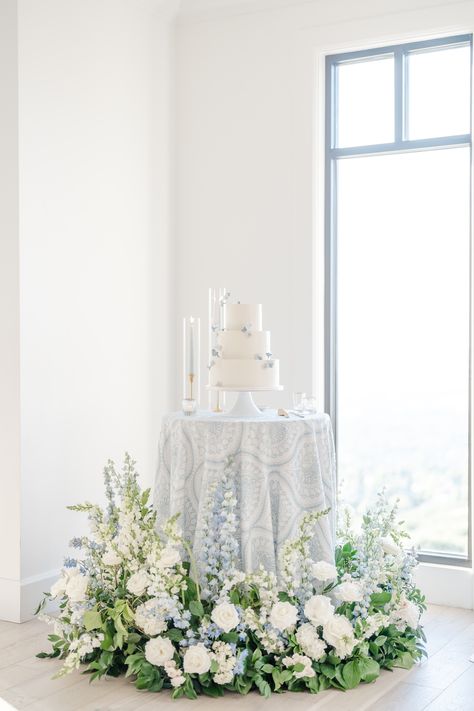 White Florals With Blue Accents, White Wedding Cake White Flowers, Blue And White Floral Wedding Cake, Powder Blue Theme Wedding, White Wedding Flowers With Pop Of Blue, Dusty Blue Cake Table, Blue And White Wedding Theme Decor, Wedding Florals Blue And White, Blue White And Green Wedding Flowers