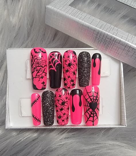 Please read full description. These nails are a beautiful bright pink with a little bit of everything. Handpainted black webs, black drips, and stitch design along with black sugar glittered ring fingers. Spiders, webs, and spooky art on every finger. Perfect for Halloween.  They are shown in a long square shape, but are available in multiple shapes, lengths, and sizes. I offer hand-painted press-on nails made with high quality Apres Gel-X soft gel nail tips and gel polish. Gel polish will give Coffin Nails Designs Halloween, Hot Pink And Black Halloween Nails, Pink And Black Nails Halloween, Pink Black Halloween Nails, Halloween Nails Pink And Black, Pink And Black Halloween Nails, Pink Goth Nails, Pink Spooky Nails, Saved Nails